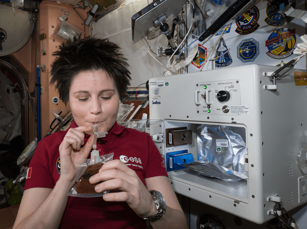 Astronaut Samantha Cristoforetti drinks from the ISSpresso coffee machine
